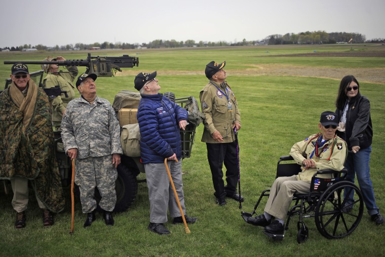 World War II 101st Airborne veterans Tom Rice, Vince Speranza, XXX, Dan McBride, and Bob Izumi watch as the U.S. Army's Golden Knights parachute team performs.
