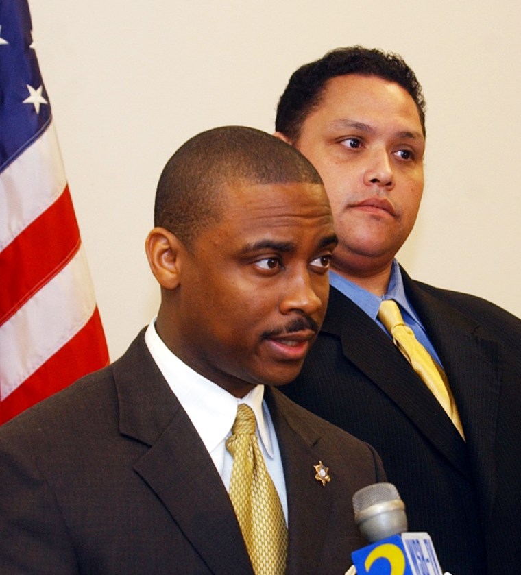 Clayton County Sheriff Victor Hill, left, is flanked by a member of his legal team, attorney Rolf Jones, right, as he speaks on Jan. 11, 2005, in Jonesboro, Ga.