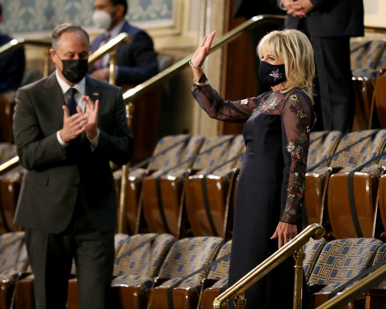 Image: Second gentleman Doug Emhoff claps as first lady Jill Biden waves before President Joe Biden's joint address to Congress at the Capitol on April 28, 2021.
