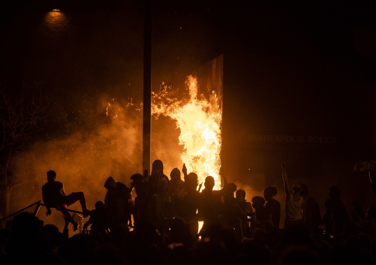Image: Protesters cheer as the Third Police Precinct burns behind them on May 28, 2020 in Minneapolis, Minn.