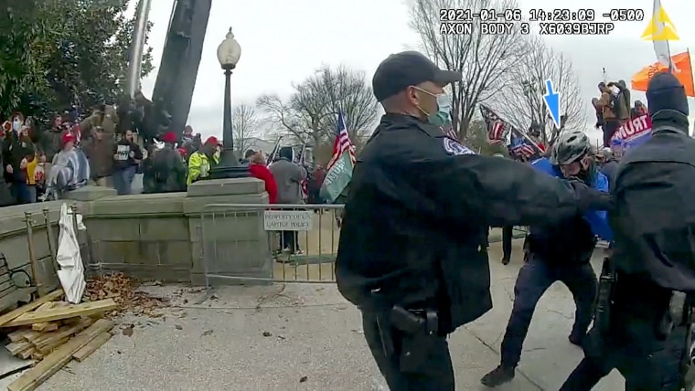 Videos that show Capitol Police Officer Brian Sicknick being hit with a chemical spray and the moments that followed during the January 6 riot.