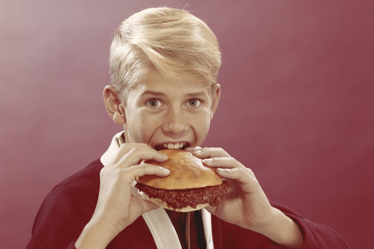 Boy eating burger, portrait