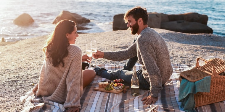 Shot of a happy young couple having a picnic and toasting with wine at the beach. Shop the best picnic baskets and picnic blankets for the perfect picnic. Find the best picnic accessories from Amazon, Target, Bed Bath & Beyond and more.