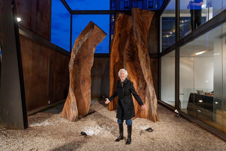 Emilie Brzezinski stands besides her sculptures.