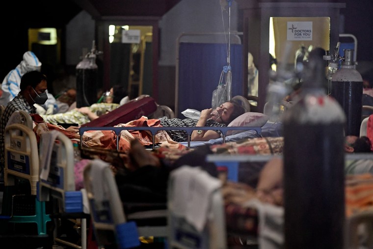 Image: Covid-19 patients inside a banquet hall temporarily converted into a care center in New Delhi