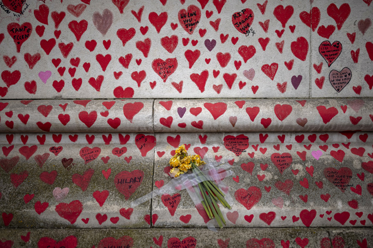 Image: Daffodils are taped to the National Covid Memorial Wall on April 21, 2021 in London.