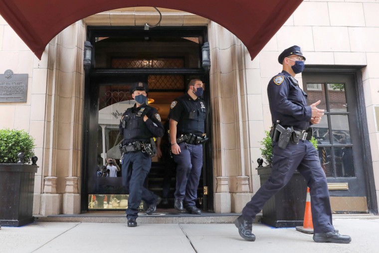 Image: Officers from the New York Police Department (NYPD) are seen exiting the apartment building of Former New York City Mayor Rudy Giuliani, personal attorney to U.S. President Donald Trump, in Manhattan, New York City, New York