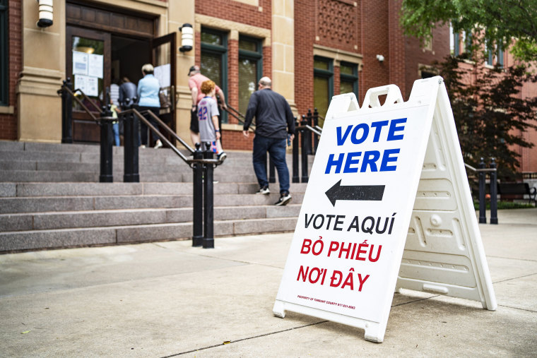 IMAGE: People walk into Southlake Town Hall to vote in municipal elections in Southlake, Texas, on May 1, 2021.