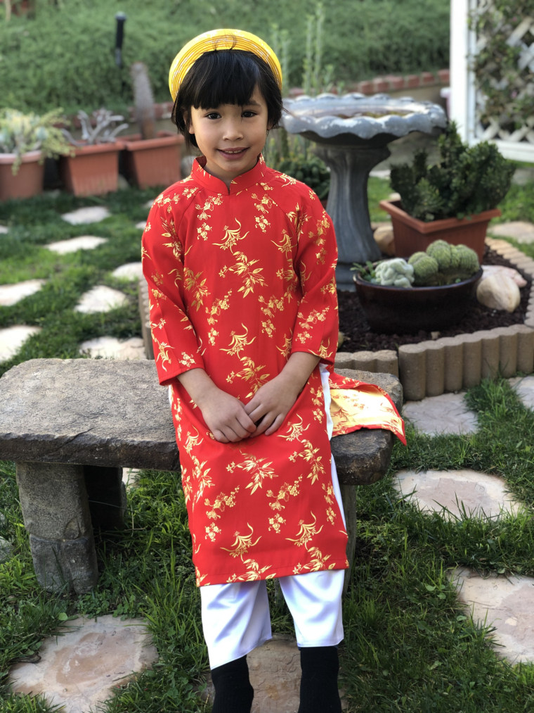The author's daughter, Claire, proudly wears a traditional Vietnamese outfit.