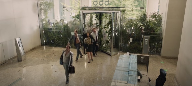 Delirious workers return to their overgrown office.