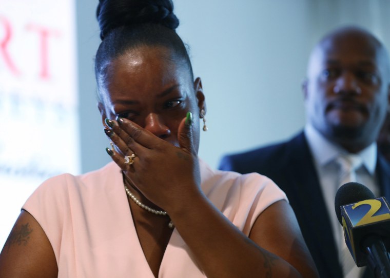 Image: Tomika Miller, the widow of Rayshard Brooks, wipes away tears as she participates in a press conference at her lawyers office after Fulton County District Attorney Paul L. Howard, Jr. announced 11 charges against former Atlanta Police Officer Garre