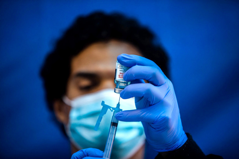 Image: A medical worker loads a syringe with the Moderna Covid-19 vaccine to be administered by nurses at a vaccination site at Kedren Community Health Center, in South Central Los Angeles on Feb. 16, 2021.