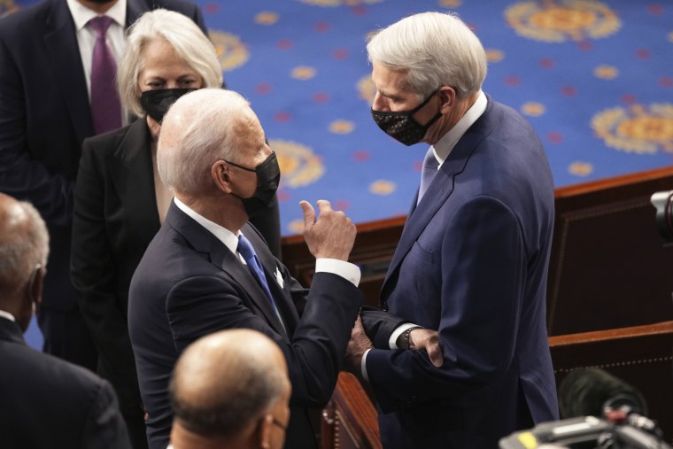 President Joe Biden greets Sen. Rob Portman, R-Ohio, after speaking to a joint session of Congress on April 28, 2021.