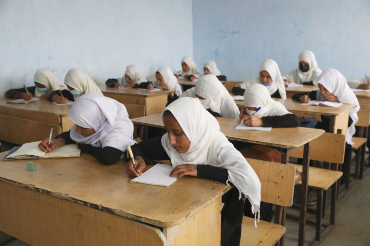 Image: Students attend classes in a primary school in Kabul.