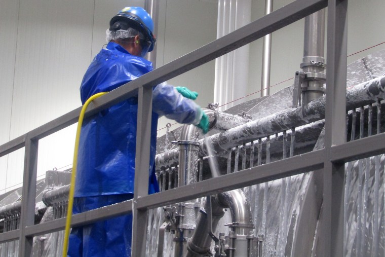 A PSSI worker cleans a chicken chiller at the House of Raeford poultry processing plant after Antonio Fonseca-Gutierrez was killed. Inspectors from the North Carolina Department of Labor came to investigate PSSI's operations at the plant after his death. The workers did not climb into the machine when inspectors were there but the agency still found violations.