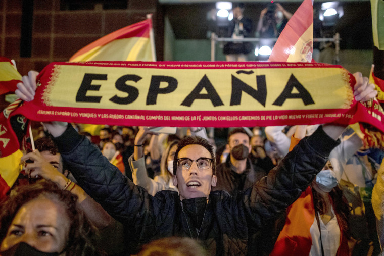 Image: People react outside the Vox party headquarters in Madrid, Spain,