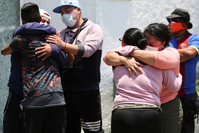Image: Relatives of the victims react outside the Prosecutor's Office after an accident where an overpass of the metro partially collapsed with train cars on it, Mexico City