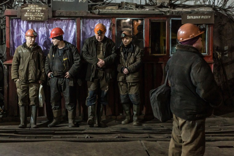 Image: Miners wait for the elevator that will take them for the 6-hour shift underground at the Tsentralna coal mine in Toretsk, Donetsk region, Ukraine