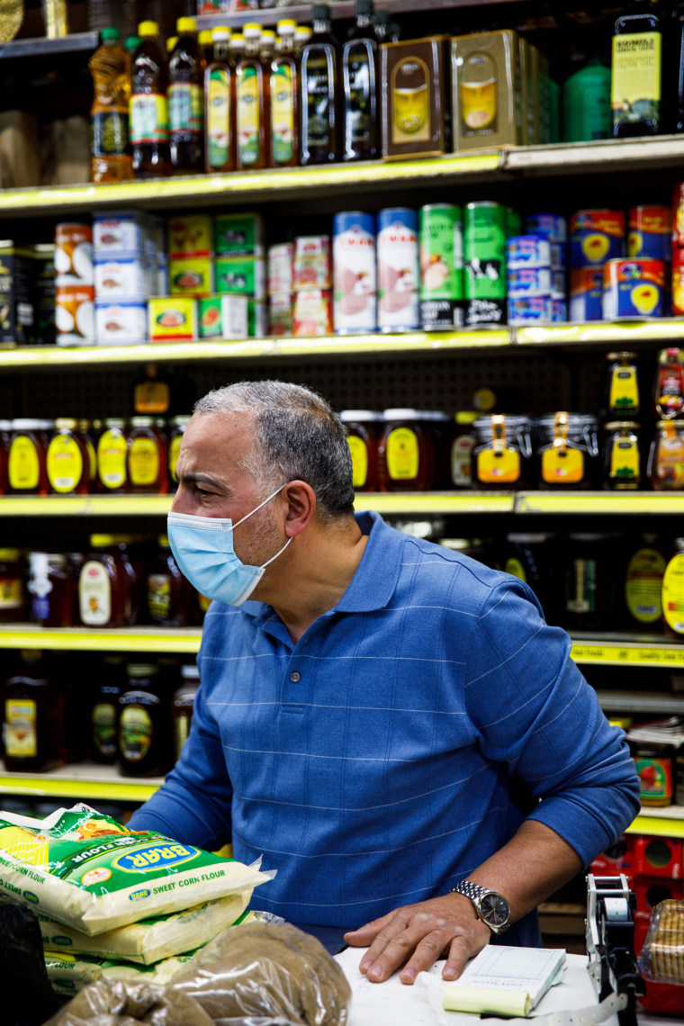 Hamed Nabawy Hamed talks with a customer at his halal grocery store Fertile Crescent in Brooklyn, N.Y., on May 5, 2021.