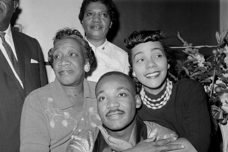 Dr. Martin Luther King, Jr., is embraced by his wife Coretta Scott King during a news conference at Harlem Hospital in New York, Sept 30, 1958. At left is his mother, Alberta Williams King.