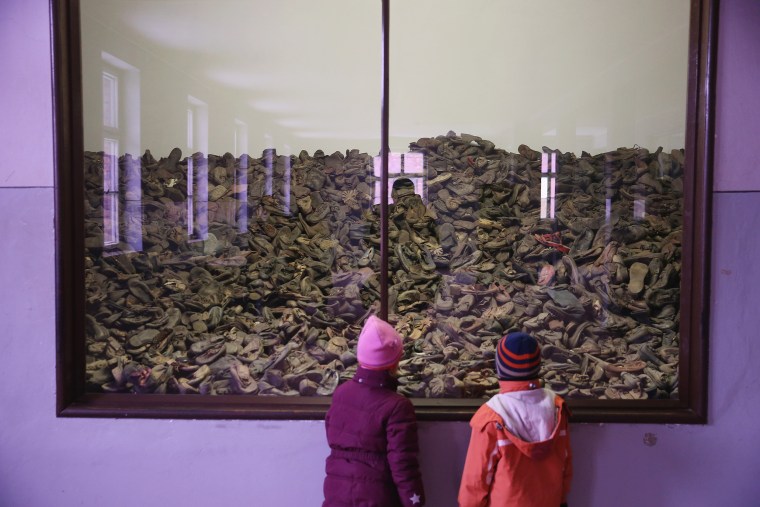 Image: Visitors look at an exhibit of shoes that belonged to Auschwitz child prisoners at the former Auschwitz I concentration camp at the museum on Jan. 25, 2015 in Oswiecim, Poland.