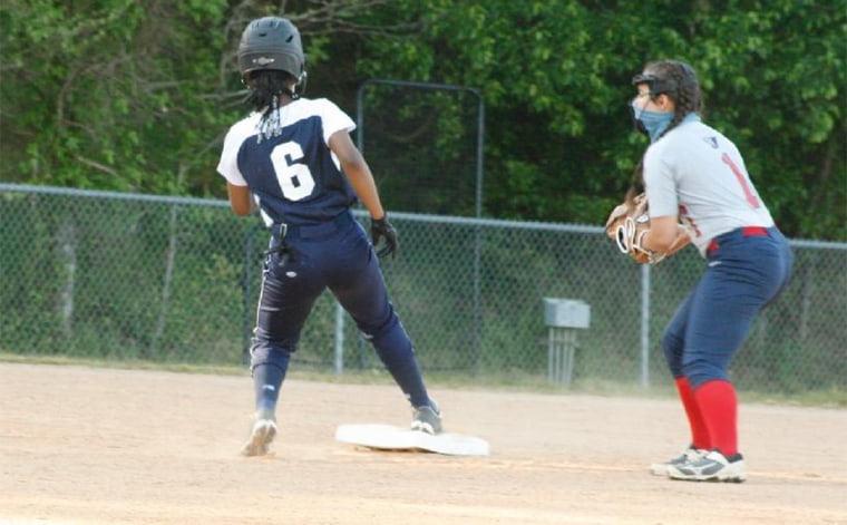 A photograph of Nicole, taken during the game, before her hair and beads were cut. 