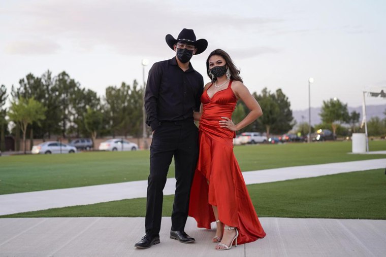 Sean de la Luz, 18, and Nalanie Miranda, 18, wear face masks for their prom at the Grace Gardens Event Center in El Paso, Texas on Friday, May 7, 2021.