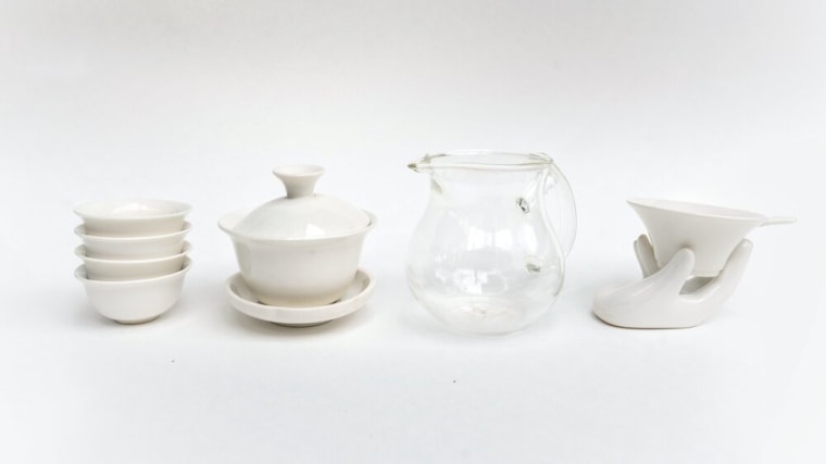 From left to right: traditional Chinese tea cups, a gaiwan, the fairness pitcher and a porcelain strainer.