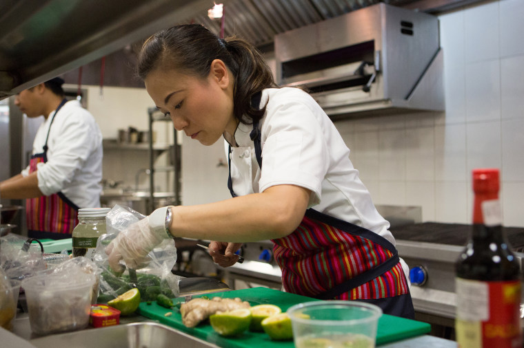 Shirley Chung looks intently at her work as she prepares a dish on the set of "Top Chef"