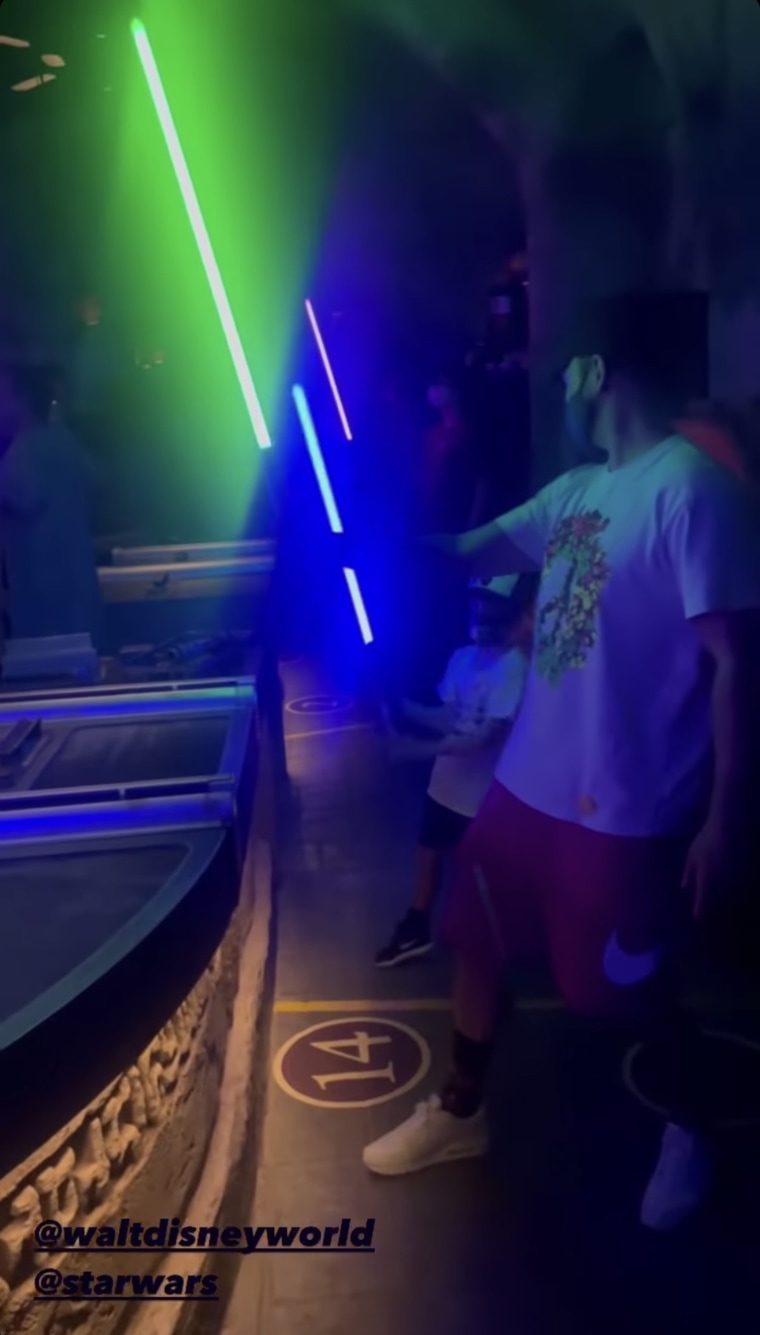 Justin Timberlake and his six year old son Silas trying out their newly assembled lightsabers at Disney World.