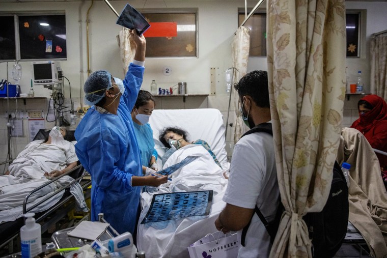 Image: Rohan Aggarwal, 26, a resident doctor looks at a Coovid-19 patient's x-ray scan, inside the emergency room of Holy Family Hospital, during his 27-hour shift in New Delhi, India, May 1, 2021.