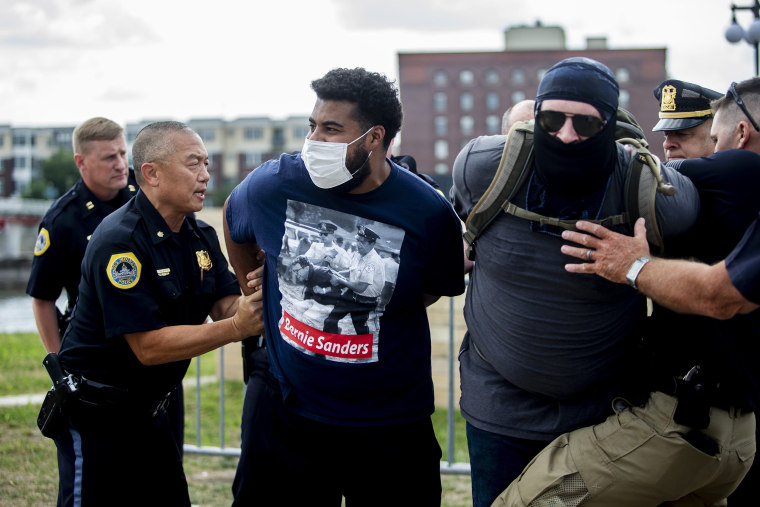 Image: Police arrest Jaylen Cavil outside of the police station in downtown Des Moines on July 2, 2020.