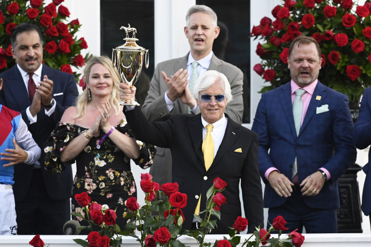 Trainer Bob Baffert celebrates with the winners trophy after his horse Medina Spirit won the 147th running of the Kentucky Derby at Churchill Downs in Louisville, Ky., on May 1, 2021.