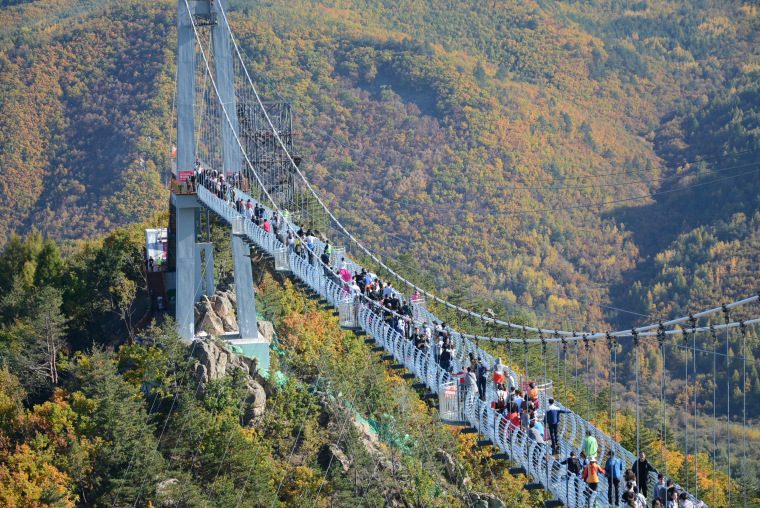 Image: Jilin's first 5D glass-bottomed bridge attracted lots of visitors during the National Day holiday in Longjing city, northeast China's Jilin province