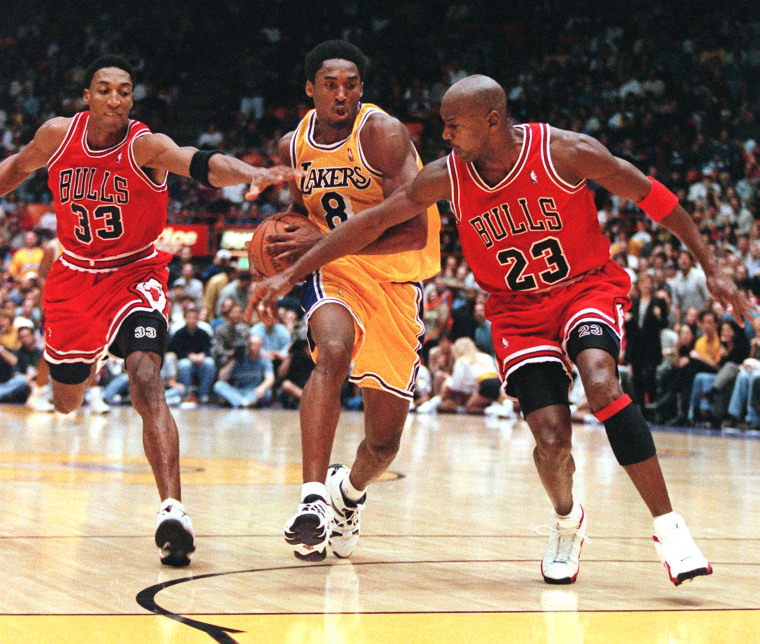 Scottie Pippen and Michael Jordan of the Chicago Bulls try to stop Kobe Bryant of the Los Angeles Lakers as he leads a fast break during a game on Feb. 1, 1998, in Los Angeles.