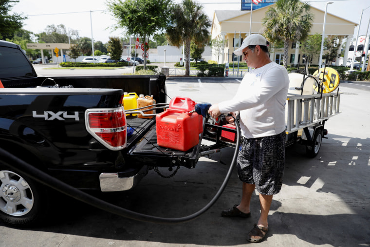 Dax Valenti fills up gas canisters at a gas station in Tampa, Fla., on May 12, 2021.