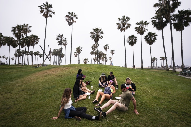 A group of friends, who said they are fully vaccinated for Covid-19, relax on the beach in the Venice section of Los Angeles on May 5, 2021.