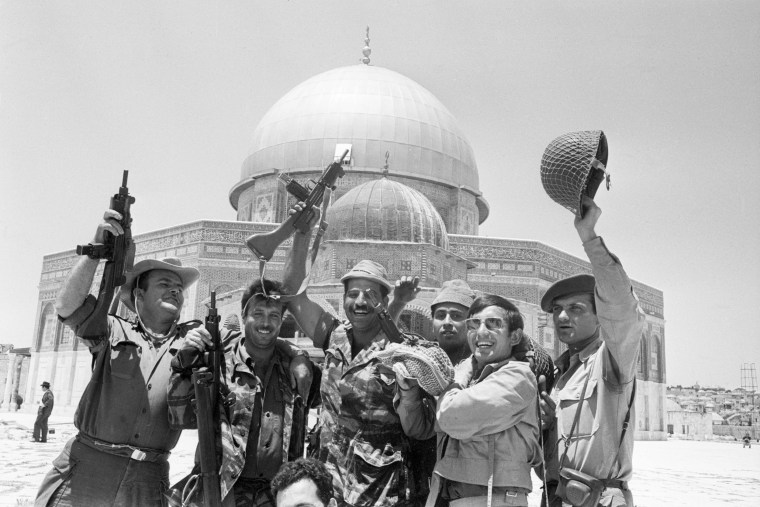 Image: Israeli soldiers celebrate the capture of Old Jerusalem from the Jordanians. They cheer in front of the Dome of the Rock, a mosque sacred to all Muslims.