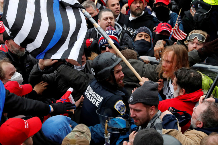 Trump supporters clash with D.C. police officer Michael Fanone at the U.S. Capitol on Jan. 6, 2021.