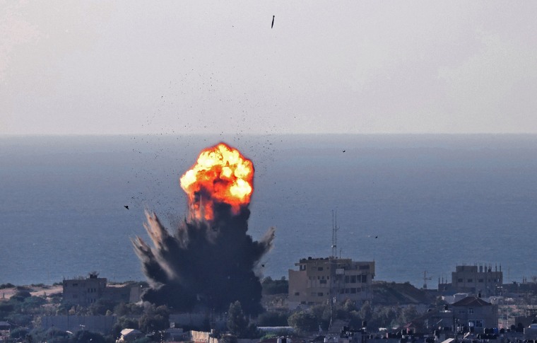 Smoke billows from an explosion as another bomb, top, falls during an Israeli airstrike in Rafah in the southern Gaza Strip on May 13, 2021.