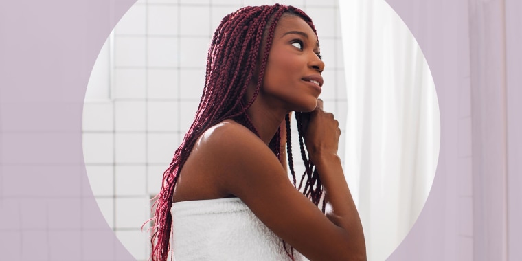 Woman wearing a white towel in bathroom taking care of her hair