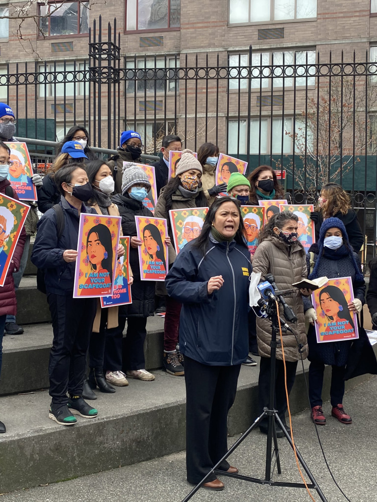 Commissioner Carmleyn P. Malalis of the NYC Commission on Human Rights speaks at a rally after the attack of a Filipino woman on her  way to church. Many of the attendees are carrying Phingbodhipakkiya's artwork.