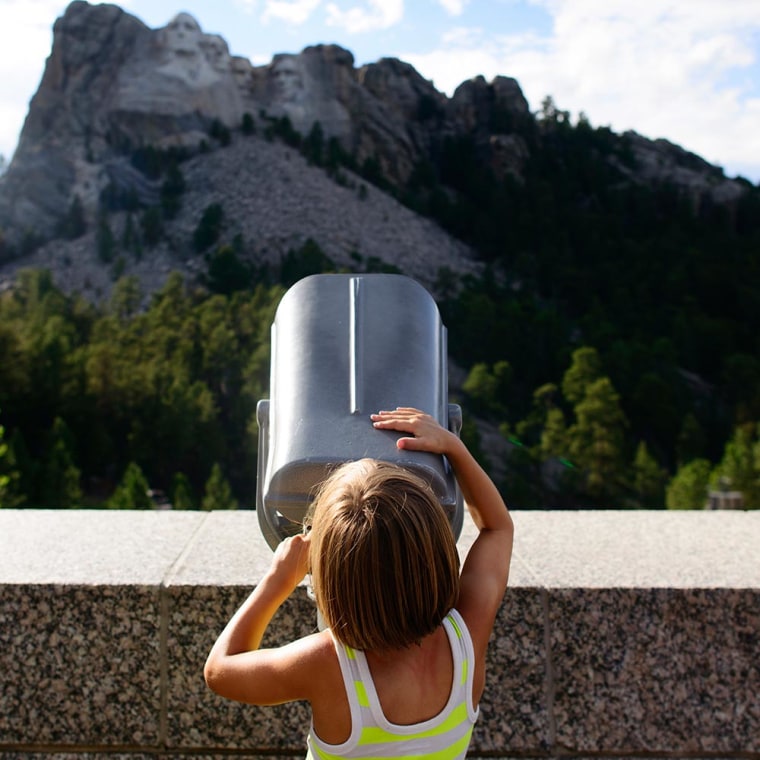 Little girl in Black Hills looking at Mount Rushmore