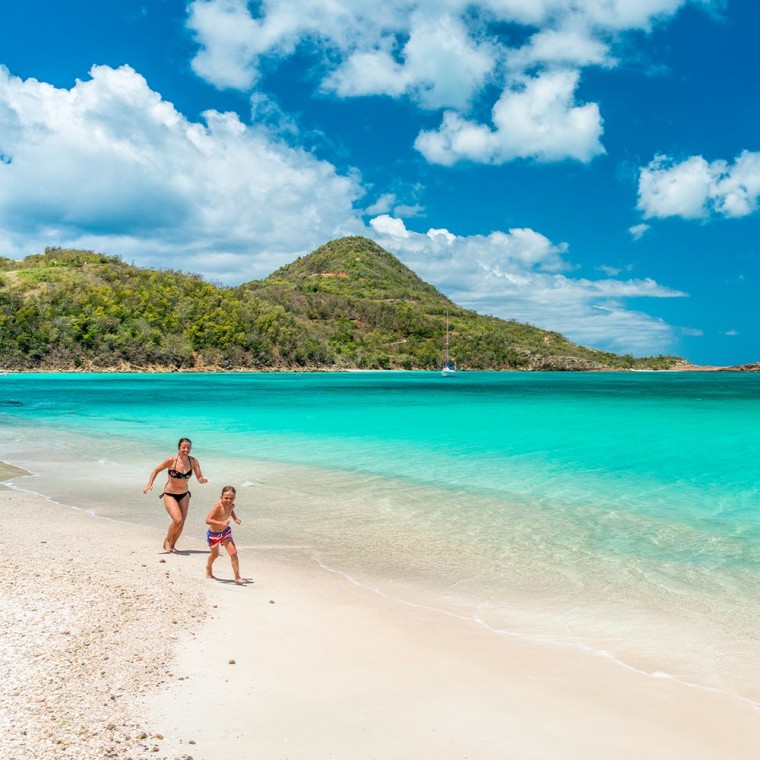 Mother and Son running on beach in St. Lucia