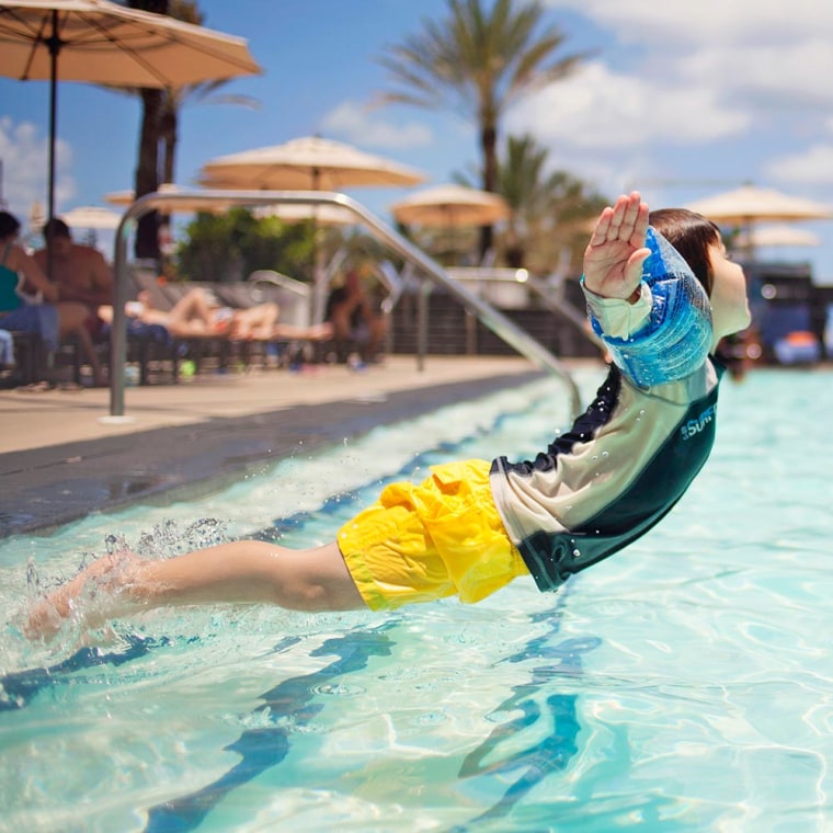 Child jumping into pool