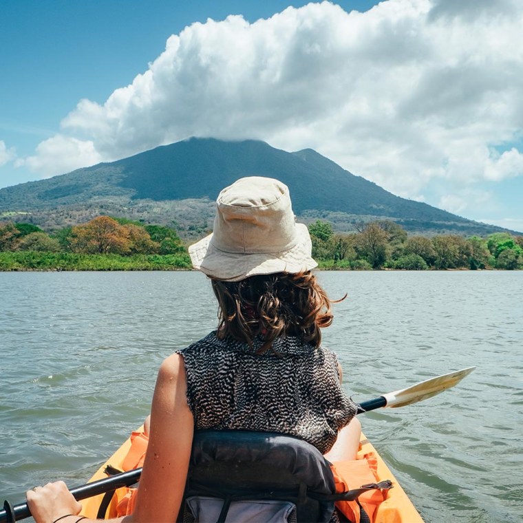 Woman kayaking on river