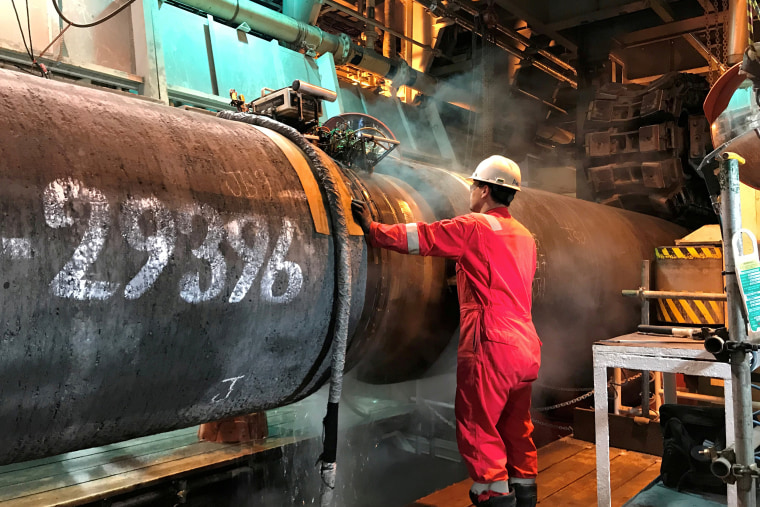 Image: FILE PHOTO: A specialist works onboard the Allseas' deep sea pipe laying ship Solitaire to prepare a pipe for Nord Stream 2 pipeline in the Baltic Sea