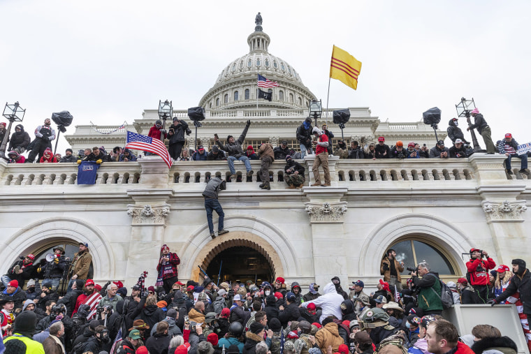 Image: Protesters climb over Capitol building where pro-Trump supporters riot and breached the Capitol,