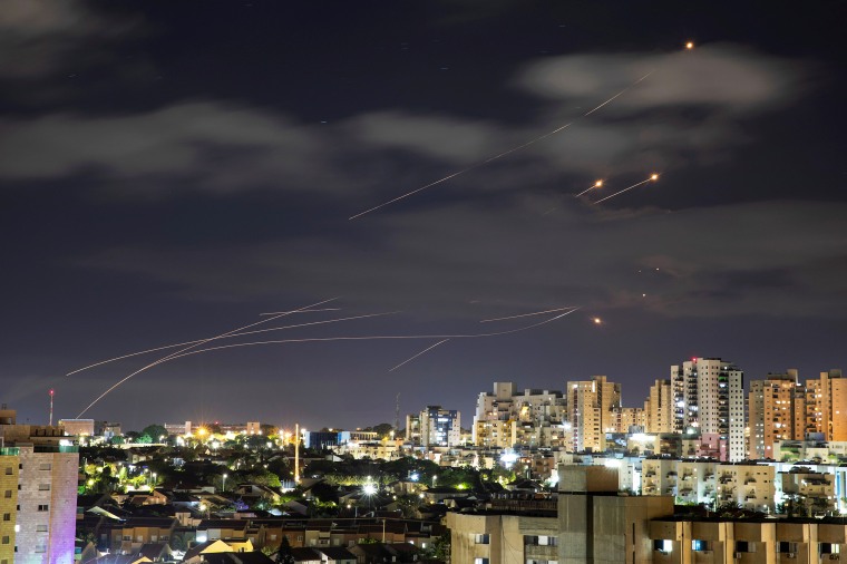 Image: Streaks of light are seen as Israel's Iron Dome anti-missile system intercepts rockets launched from the Gaza Strip towards Israel, as seen from Ashkelon, Israel