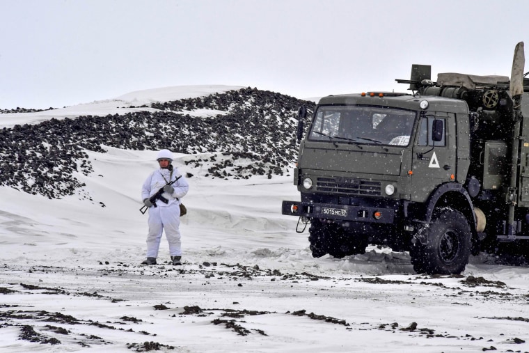 A Russian serviceman stands guard by a military truck on the island of Alexandra Land, part of the Franz Josef Land archipelago, on May 17.